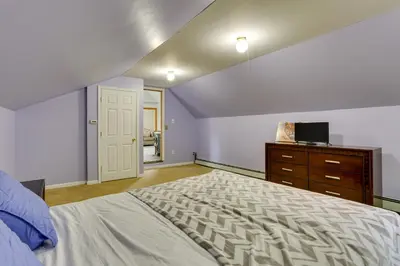 a bedroom with a bed and a dresser with a tv at Bushkill Home with Access to Pools and Tennis Courts! in Bushkill