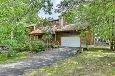 a house with a garage and a driveway at Bushkill Home with Access to Pools and Tennis Courts! in Bushkill