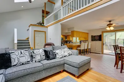 a living room with a couch and a dining room at Bushkill Home with Access to Pools and Tennis Courts! in Bushkill