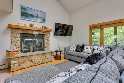 a living room with two couches and a fireplace at Bushkill Home with Access to Pools and Tennis Courts! in Bushkill