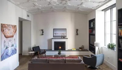 a living room with a couch and a fireplace at ROOST Midtown in Philadelphia