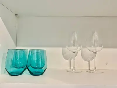 three wine glasses sitting on top of a counter at 503 Bohemian Romance Apartments in center city in Philadelphia