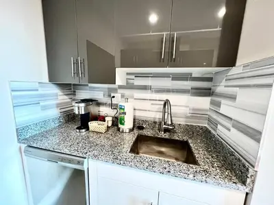 a kitchen with a sink and a counter top at 503 Bohemian Romance Apartments in center city in Philadelphia