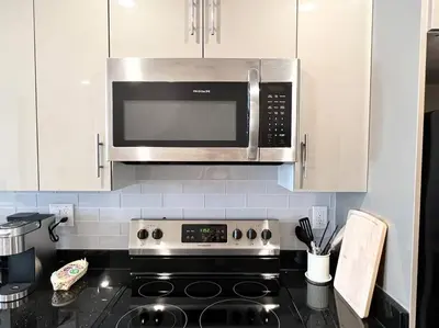 a kitchen with a stove and a microwave at 503 Bohemian Romance Apartments in center city in Philadelphia