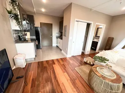 a living room with a table and a kitchen at 503 Bohemian Romance Apartments in center city in Philadelphia