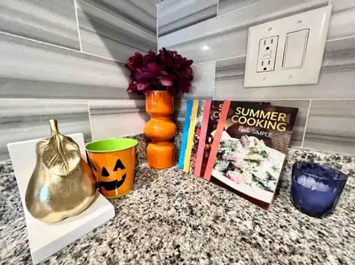 a counter with a book and a vase and books at 504 Luxe 1BDR APT in center city in Philadelphia