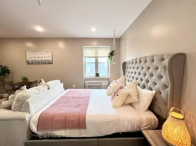 a bedroom with a large bed with a large headboard at 502 Luxury 1BR apartment in center city in Philadelphia