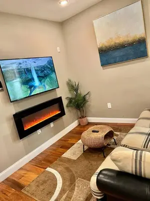 a living room with a couch and a fireplace at 505 Relaxing 1BR apartment in center city of Philly in Philadelphia