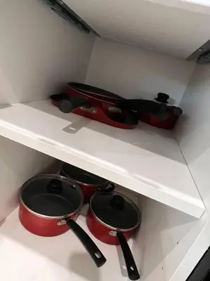a shelf with pots and utensils in a kitchen at 505 Relaxing 1BR apartment in center city of Philly in Philadelphia