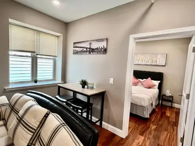 a bedroom with a bed and a table with a desk at 505 Relaxing 1BR apartment in center city of Philly in Philadelphia