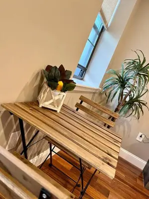 a wooden table with a bench and a plant at 508 Urban Lifestyle king bed APT in Center CITY in Philadelphia