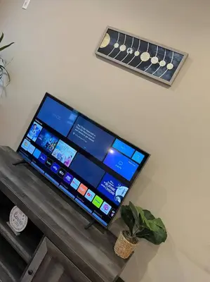 a computer monitor sitting on top of a wooden table at 508 Urban Lifestyle king bed APT in Center CITY in Philadelphia