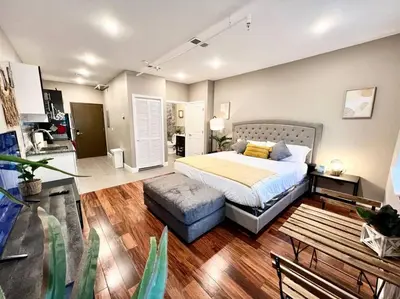 a bedroom with a bed and a ottoman in it at 508 Urban Lifestyle king bed APT in Center CITY in Philadelphia