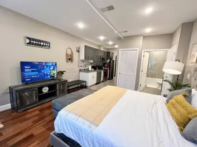 a large bedroom with a large bed and a kitchen at 508 Urban Lifestyle king bed APT in Center CITY in Philadelphia