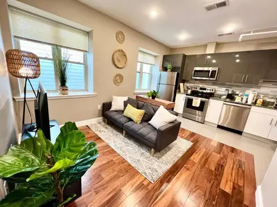 a living room with a couch and a kitchen at 501 Cozy and Comfy 1BR apartment in center city in Philadelphia