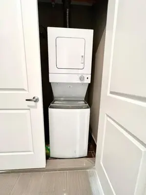a washer and dryer sitting next to a door at 501 Cozy and Comfy 1BR apartment in center city in Philadelphia