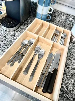 a wooden tray with knives and utensils on a counter at 501 Cozy and Comfy 1BR apartment in center city in Philadelphia