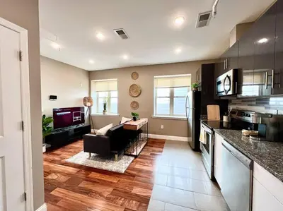 a kitchen and living room with a couch and a table at 501 Cozy and Comfy 1BR apartment in center city in Philadelphia