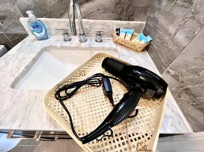 a hair dryer sitting on a bathroom sink at 501 Cozy and Comfy 1BR apartment in center city in Philadelphia