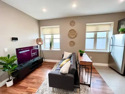 a living room with a couch and a refrigerator at 501 Cozy and Comfy 1BR apartment in center city in Philadelphia