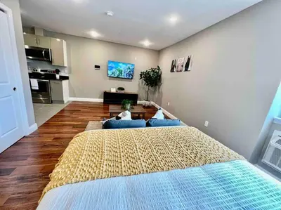a large bedroom with a large bed with blue pillows at 402 Stylish luxe Apt at center city self check-in in Philadelphia