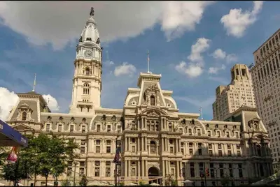 a large building with a clock tower on top of it at 402 Stylish luxe Apt at center city self check-in in Philadelphia