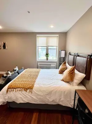 a bedroom with a large bed and a window at 402 Stylish luxe Apt at center city self check-in in Philadelphia