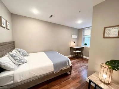 a bedroom with a bed and a desk in it at 407 Sweetest cottage 1bed room Apt in center city in Philadelphia