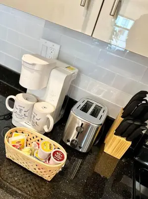 a kitchen counter with a coffee maker and a basket of food at 407 Sweetest cottage 1bed room Apt in center city in Philadelphia