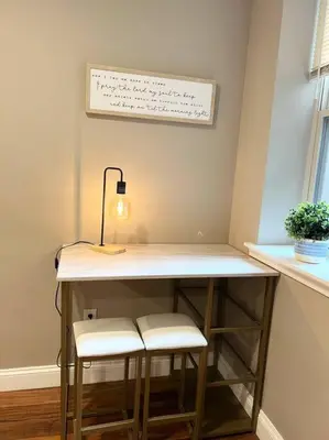 a table with two stools and a lamp on top at 407 Sweetest cottage 1bed room Apt in center city in Philadelphia