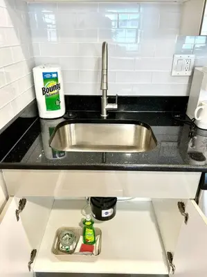 a kitchen counter with a sink in a kitchen at 407 Sweetest cottage 1bed room Apt in center city in Philadelphia
