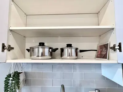 two pots sitting on a shelf in a kitchen at 408 Modern styles apartment in center city of Philly in Philadelphia