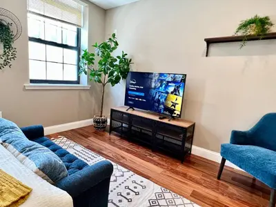 a living room with a flat screen tv on a table at 408 Modern styles apartment in center city of Philly in Philadelphia