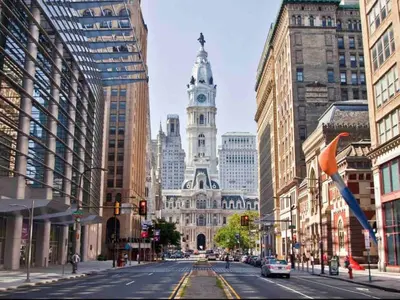 a city street with a building with a clock tower at 302 Comfy Cabin 1BD with city view in Center city in Philadelphia