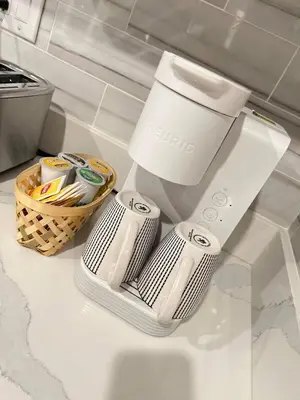 a kitchen counter with a coffee maker and a basket at 302 Comfy Cabin 1BD with city view in Center city in Philadelphia