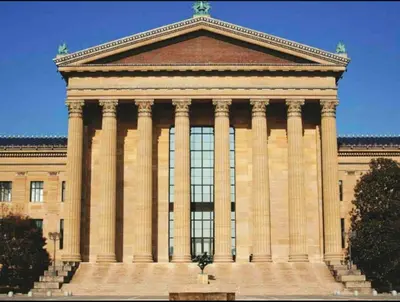 a large building with columns on top of it at 302 Comfy Cabin 1BD with city view in Center city in Philadelphia