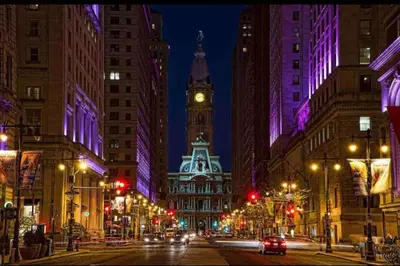 a city street at night with a clock tower at 302 Comfy Cabin 1BD with city view in Center city in Philadelphia