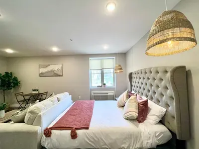 a bedroom with a large bed and a couch at 302 Comfy Cabin 1BD with city view in Center city in Philadelphia
