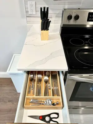 a kitchen counter with a drawer full of utensils at 303 Cozy and modern 1BR apartment in center City in Philadelphia
