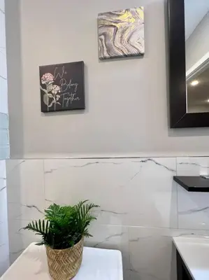 a bathroom with a potted plant sitting on a counter at 303 Cozy and modern 1BR apartment in center City in Philadelphia