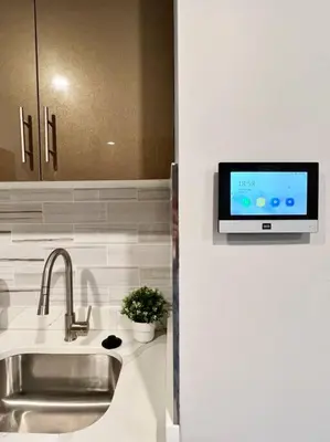 a kitchen with a sink and a tv on the wall at 303 Cozy and modern 1BR apartment in center City in Philadelphia