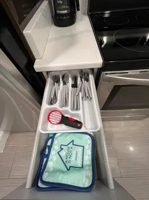 a refrigerator filled with utensils in a drawer at 305 Cozy and lovely 1BDR apartment in Center City in Philadelphia