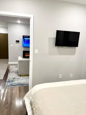 a bedroom with a flat screen tv on a wall at 305 Cozy and lovely 1BDR apartment in Center City in Philadelphia