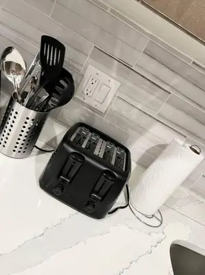 a kitchen counter with a black container and utensils at 305 Cozy and lovely 1BDR apartment in Center City in Philadelphia