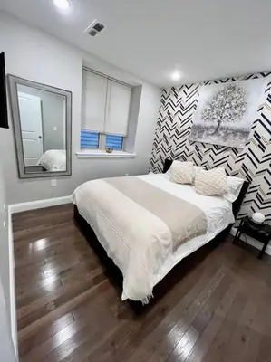 a bedroom with a large bed and a mirror at 305 Cozy and lovely 1BDR apartment in Center City in Philadelphia