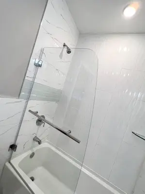 a white bathroom with a tub and a mirror at 305 Cozy and lovely 1BDR apartment in Center City in Philadelphia