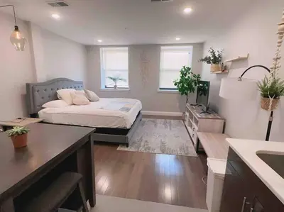 a bedroom with a bed and a desk in a room at 308 Cozy and warm King Bed APT in center city in Philadelphia
