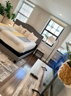 a bedroom with a bed and a glass table at 308 Cozy and warm King Bed APT in center city in Philadelphia