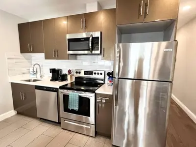 a kitchen with a stainless steel refrigerator and a stove at 307 Kyoto style 1BDR Apt in center city in Philadelphia