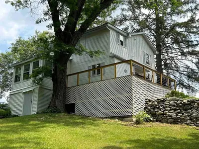 a large white house with a tree in the yard at Unique Stay! Ricketts Chic Farmhouse Retreat with Stargazing Bubble Tent in Stillwater